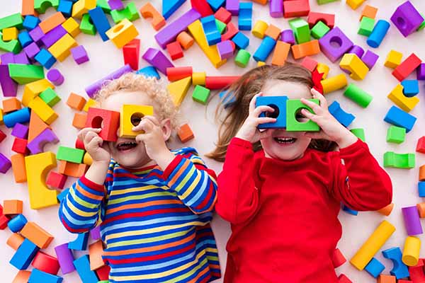 Toddlers playing brain boosting building blocks game
